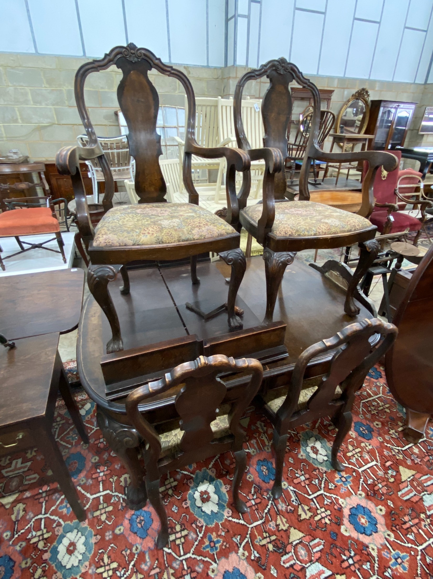 A Queen Anne revival burr walnut dining room suite, comprising extending dining table 208cm extended, two spare leaves, width 106cm, height 74cm and six dining chairs, two with arms